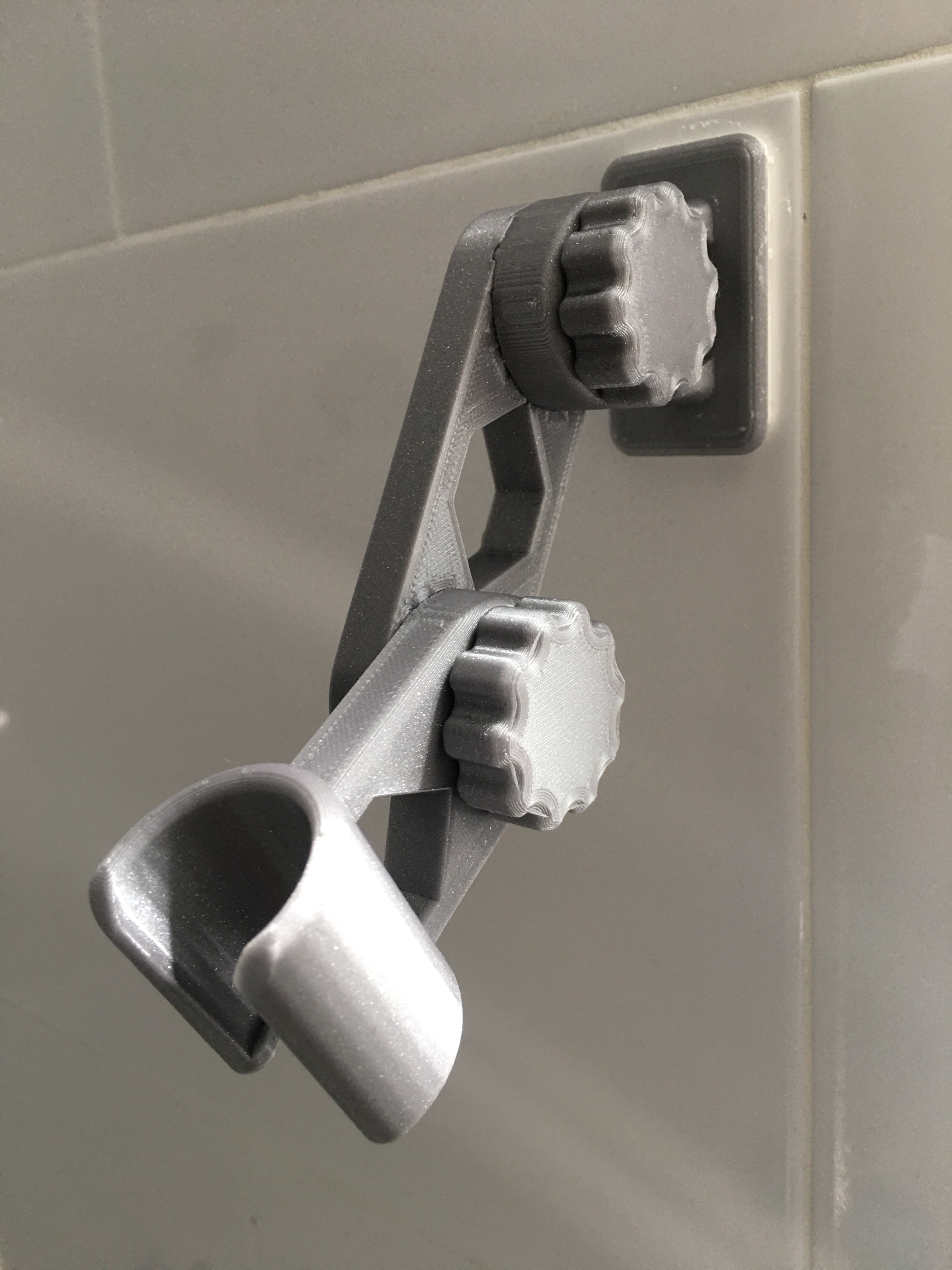 3D-printed articulating hand shower mount on the wall